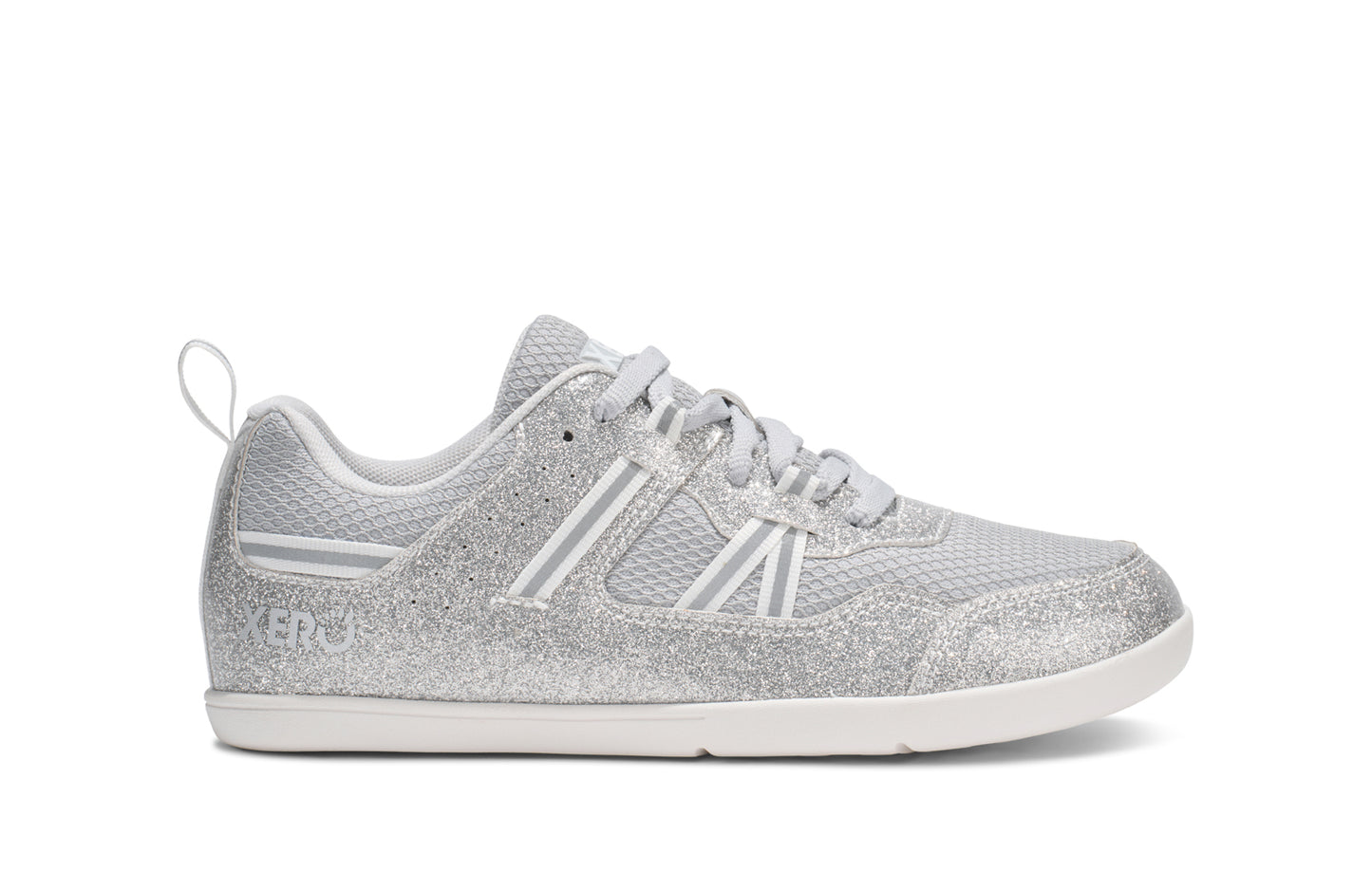 Xero Barefoot Shoes for kids sold in Ontario, Canada. These minimalist shoes have flexible soles, wide toe boxes, and zero drop. Side view of Xero Kid's Prio in Silver Glitter. Casual kid's sneaker.
