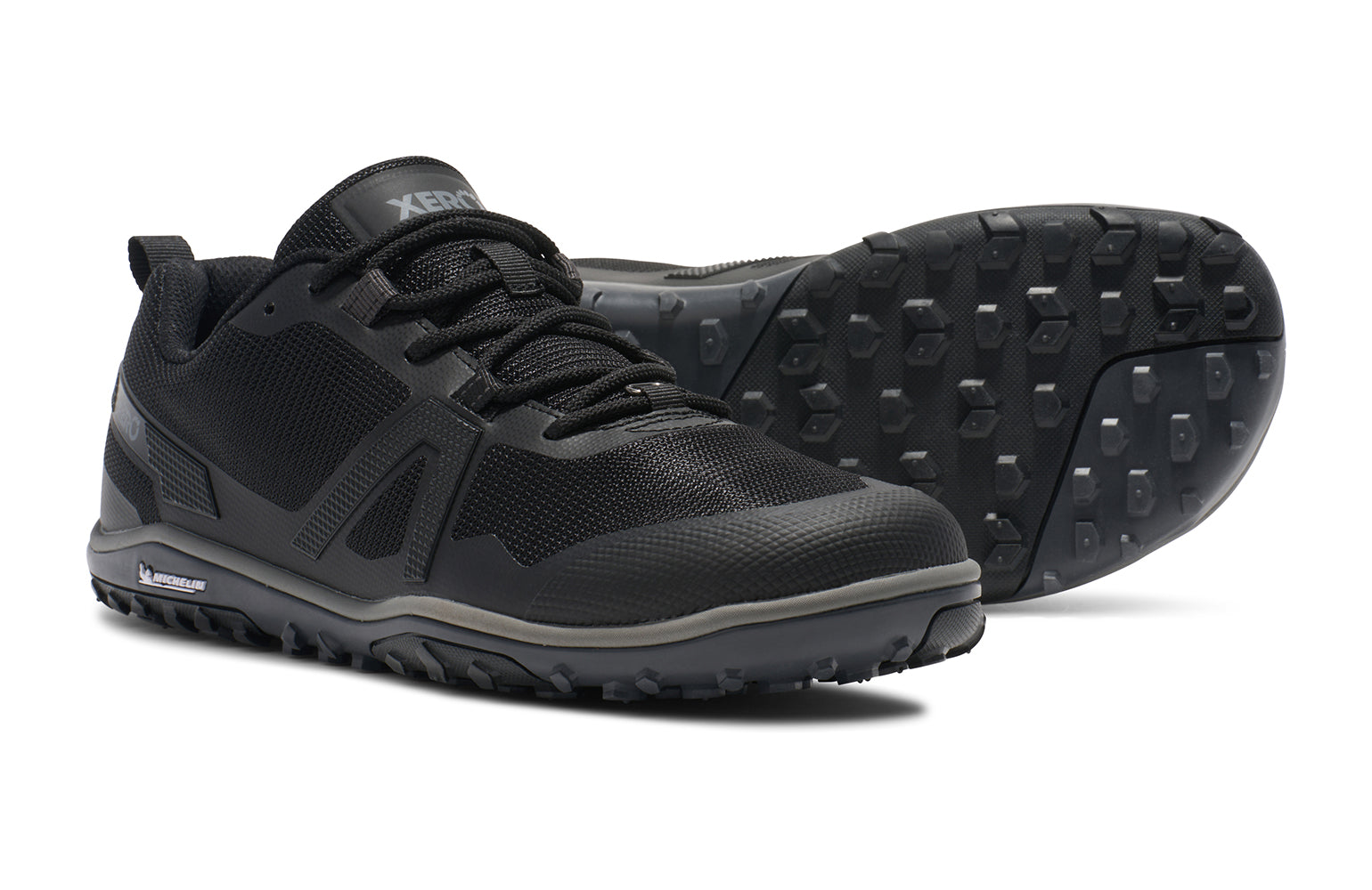 Xero Barefoot Shoes sold in Ontario, Canada. These minimalist shoes have flexible soles, wide toe boxes, and zero drop. Side and sole view of Xero Men's Scrambler Low EV in Black/Steel Gray a lightweight high-performance trail runner