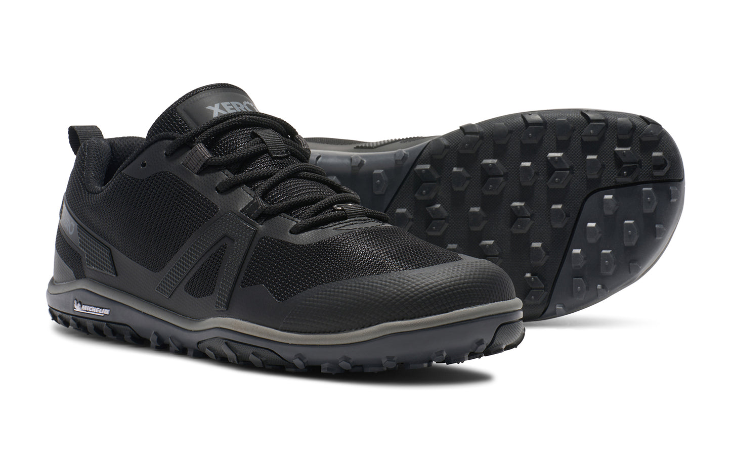 Xero Shoes Canada, specifically barefoot hiking shoes Canada. These minimalist shoes have flexible soles, wide toe boxes, and zero drop. Side and sole view of Xero Men's Scrambler Low EV in Black/Steel Gray a lightweight high-performance trail runner