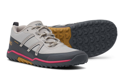 Gray and pink hiking shoes with a textured sole on a white background.  Tru Stride Co brings Xero Shoes to Canada