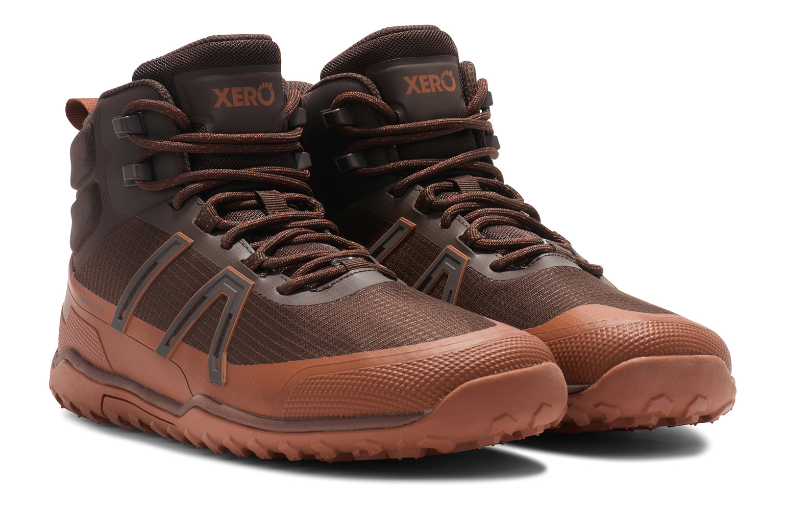Xero Shoes Canada, specifically barefoot hiking shoes Canada. These minimalist shoes have flexible soles, wide toe boxes, and zero drop. Angled view of Xero Men's Scrambler Trail Mid WP in Java Brown/Mocha Bisque - a sturdy hiking boot
