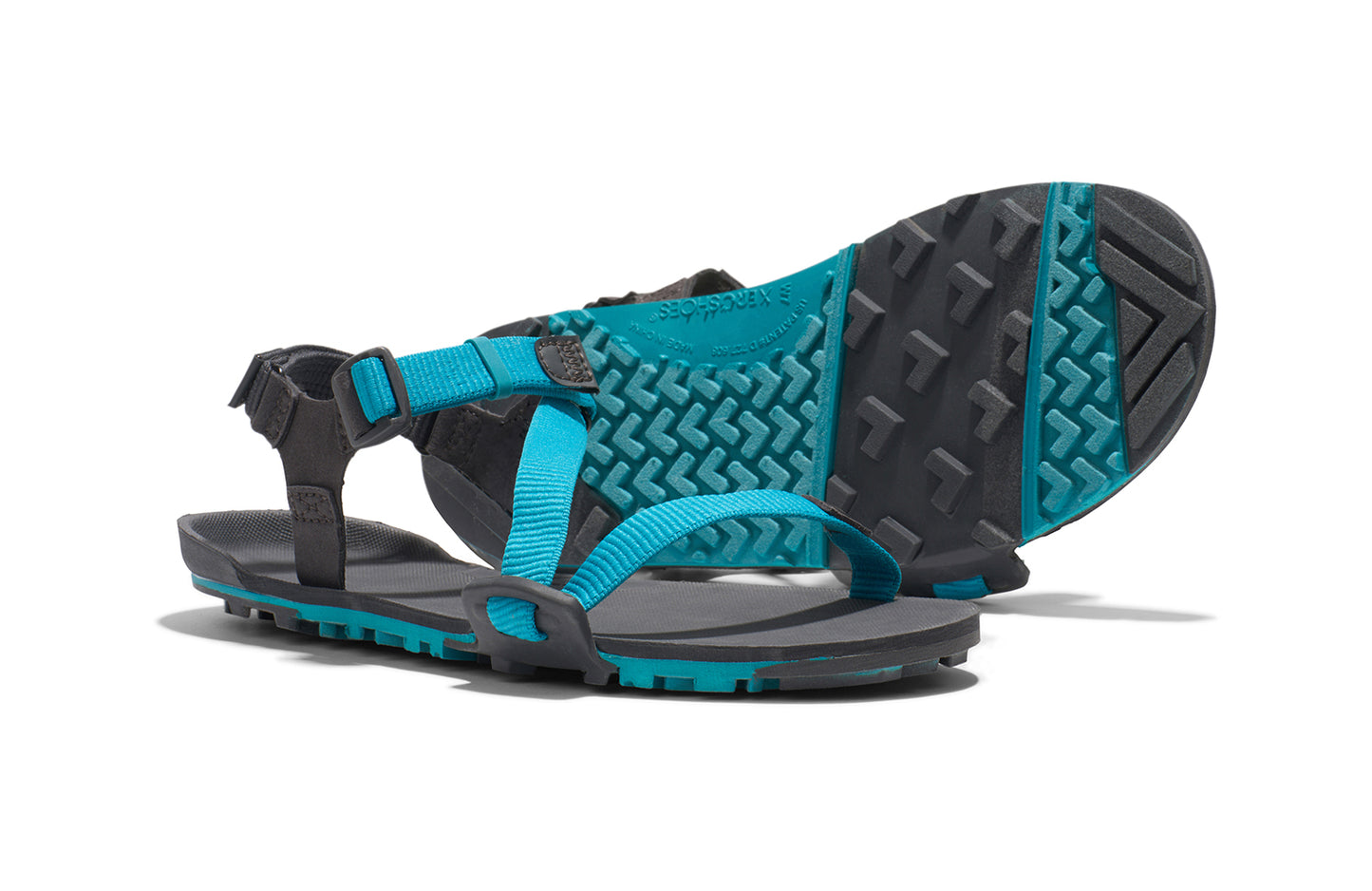 Xero Barefoot Shoes sold in Ontario, Canada. These minimalist shoes have flexible soles, wide toe boxes, and zero drop. Side and sole pair view of Xero Women's Z-Trail EV in Lake Blue/Asphalt. Trail hiking, running, and recovery sandal. 