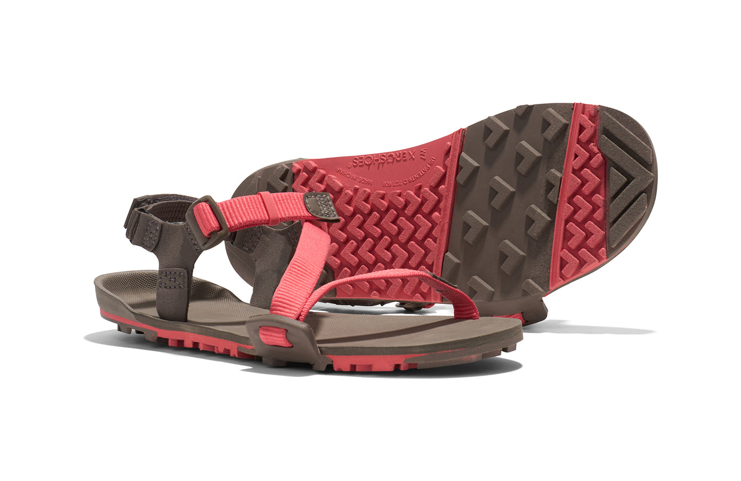 Xero Barefoot Shoes sold in Ontario, Canada. These minimalist shoes have flexible soles, wide toe boxes, and zero drop. Side and sole view of Xero Women's Z-Trail EV in Sunset Coral/Morel. Trail hiking, running, and recovery sandal. 