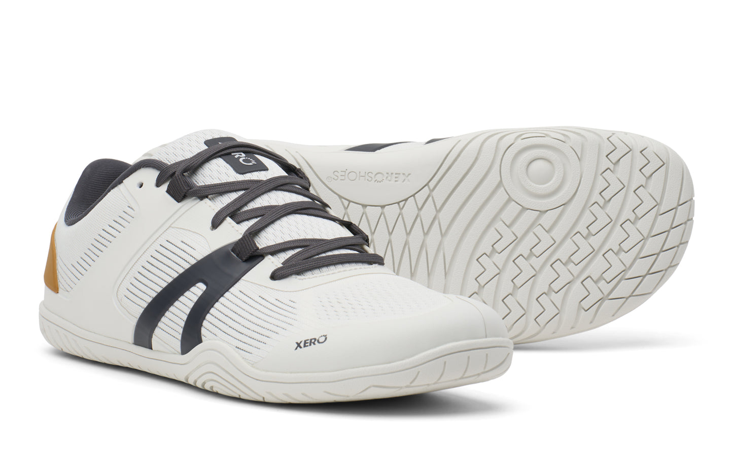 White athletic shoes with black laces on a white background.  Tru Stride Co brings Xero shoes to Canada