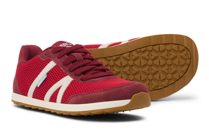 Red sneakers with white accents on a white background. Tru Stride Co brings Xero Shoes to Canada