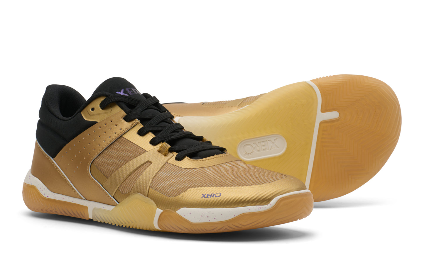 Pair of gold basketball shoes with black accents on a white background. Tru Stride Co brings Xero Shoes to Canada