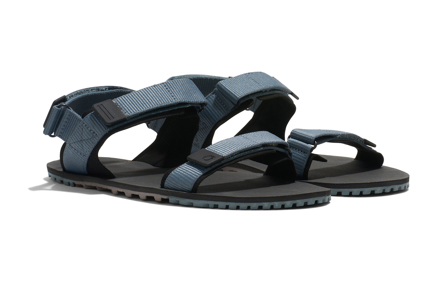 Xero Shoes Canada, specifically men’s barefoot shoes Canada. These minimalist shoes have flexible soles, wide toe boxes, and zero drop. Angled view of Xero Men's D-Trail in Stormy Weather/Black, a versatile hiking sandal.