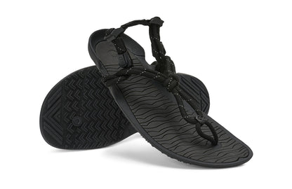 Xero Shoes Canada, specifically women’s barefoot shoes Canada. These minimalist shoes have flexible soles, wide toe boxes, and zero drop. Angled pair view of Xero Women's Aqua Cloud in Black. Versatile water sport and hiking sandal. 