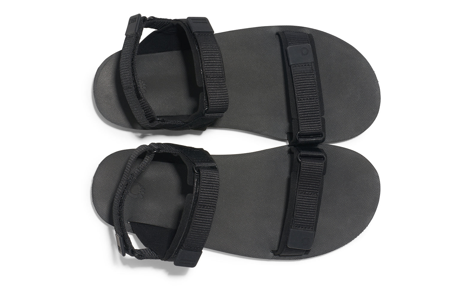 Xero Shoes Canada, specifically women’s barefoot shoes Canada.  These minimalist shoes have flexible soles, wide toe boxes, and zero drop. Top view of Xero Women's D-Trail in Black/Asphalt, a versatile hiking sandal.