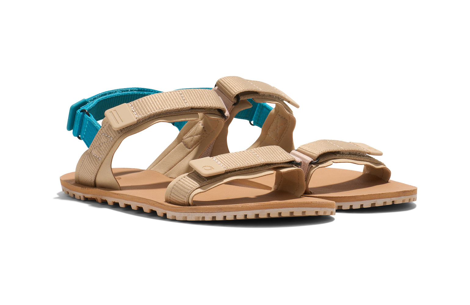 Xero Shoes Canada, specifically women’s barefoot shoes Canada.  These minimalist shoes have flexible soles, wide toe boxes, and zero drop. Angled view of Xero Women's D-Trail in Irish Cream/Lake Blue, a versatile hiking sandal.