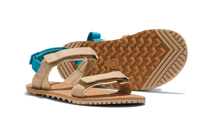 Xero Shoes Canada, specifically women’s barefoot shoes Canada. These minimalist shoes have flexible soles, wide toe boxes, and zero drop. Side and sole view of Xero Women's D-Trail in Irish Cream/Lake Blue, a versatile hiking sandal.