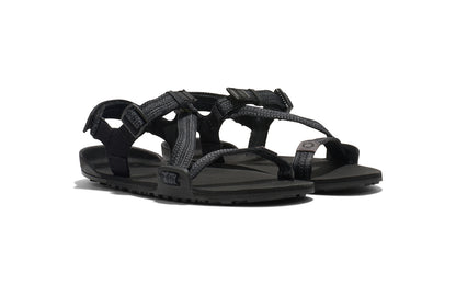 Xero Barefoot shoes for kids sold in Ontario, Canada. These minimalist shoes have flexible soles, wide toe boxes, and zero drop. Angled view of Xero Kid's Z-Trail in Black, a lightweight packable sport sandal. 