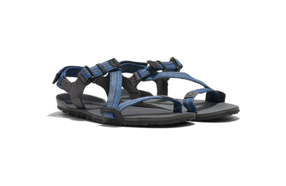 Xero Barefoot shoes for kids sold in Ontario, Canada. These minimalist shoes have flexible soles, wide toe boxes, and zero drop. Angled view of Xero Kid's Z-Trail in Blue, a lightweight packable sport sandal. 