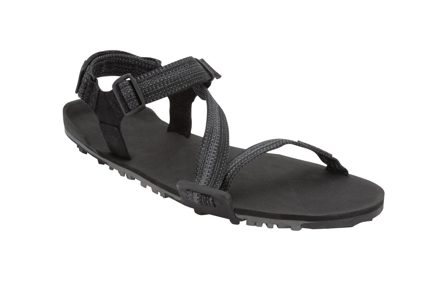 Xero Shoes Canada, specifically women’s barefoot shoes Canada. These minimalist shoes have flexible soles, wide toe boxes, and zero drop. Angled view of Xero Women's Z-Trail EV in Multi-Black. Trail hiking, running, and recovery sandal. 