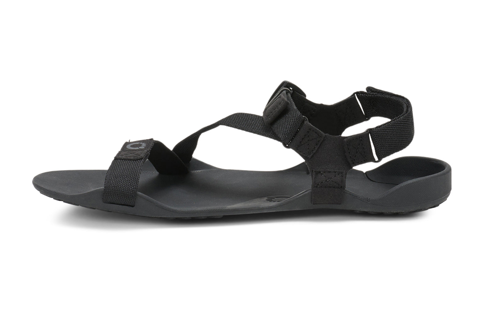 Xero Barefoot Shoes sold in Ontario, Canada. These minimalist shoes have flexible soles, wide toe boxes, and zero drop. Side view of Xero Men's Z-Trek in Black, a lightweight packable sport sandal. 