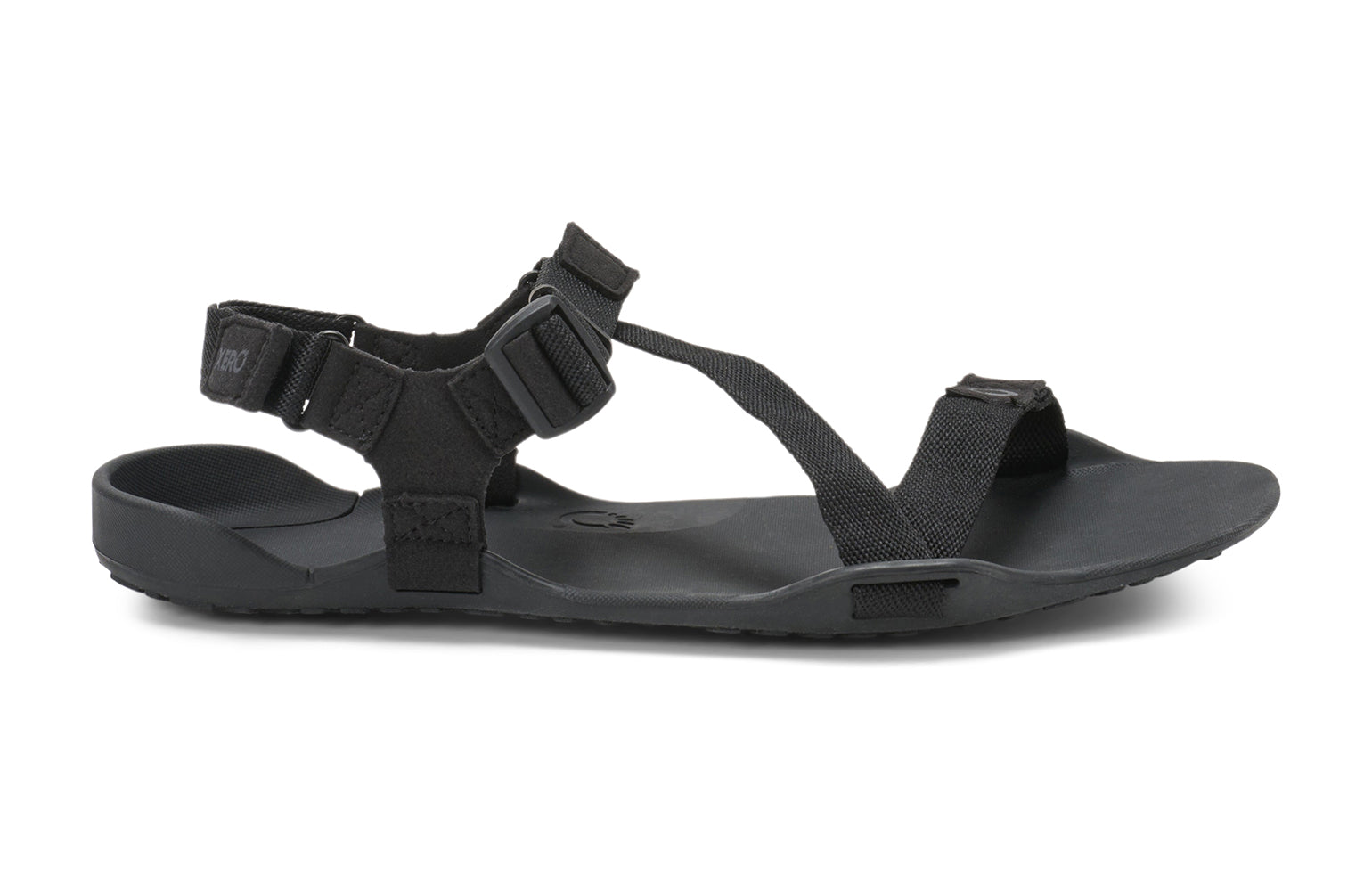 Xero Barefoot Shoes sold in Ontario, Canada. These minimalist shoes have flexible soles, wide toe boxes, and zero drop. Lateral side view of Xero Men's Z-Trek in Black, a lightweight packable sport sandal. 