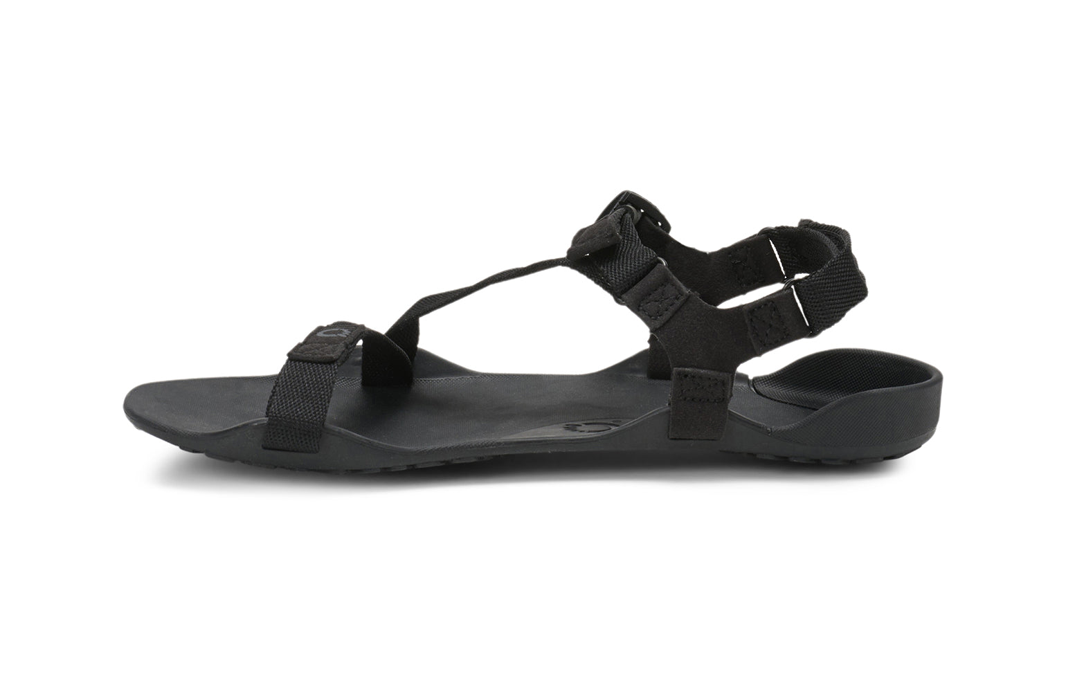 Xero Barefoot Shoes sold in Ontario, Canada. These minimalist shoes have flexible soles, wide toe boxes, and zero drop. Side view of Xero Women's Z-Trek in Black, a lightweight packable sport sandal. 
