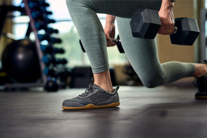 Xero Shoes Canada, specifically barefoot running shoes Canada. Woman carrying weights in Xero barefoot shoes. 