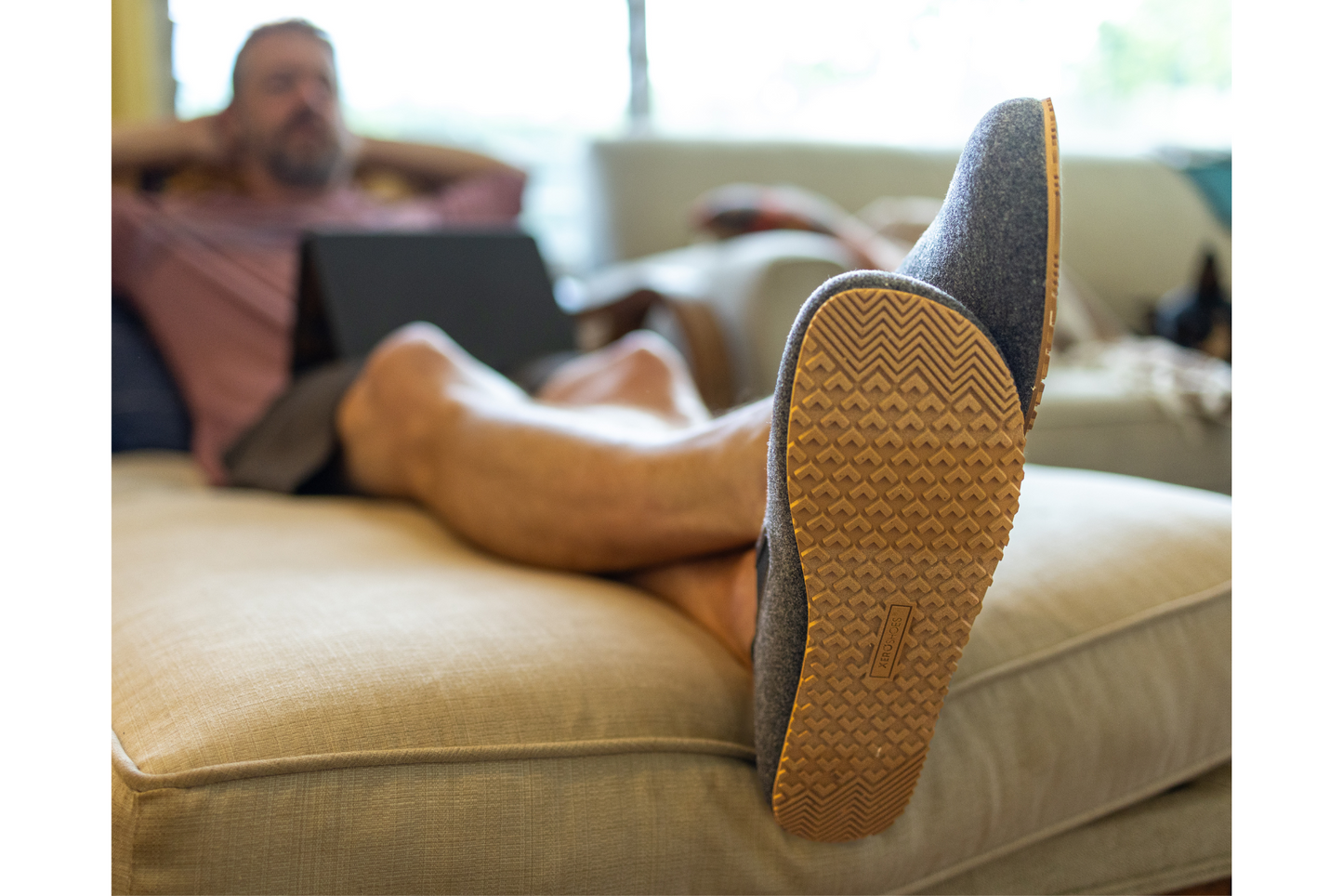 Xero Shoes Canada, specifically men’s barefoot shoes Canada. Man wearing Pagosa on couch