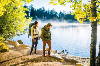 Xero Shoes Canada, specifically barefoot hiking shoes Canada. Couple wearing Scrambler Trail Mid WP by the lake